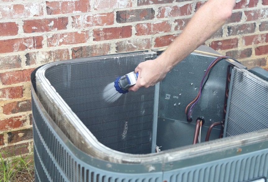 HVAC maintenance spraying coils in HVAC Unit