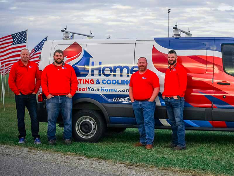 Home Heating service technicians in front of service vehicle